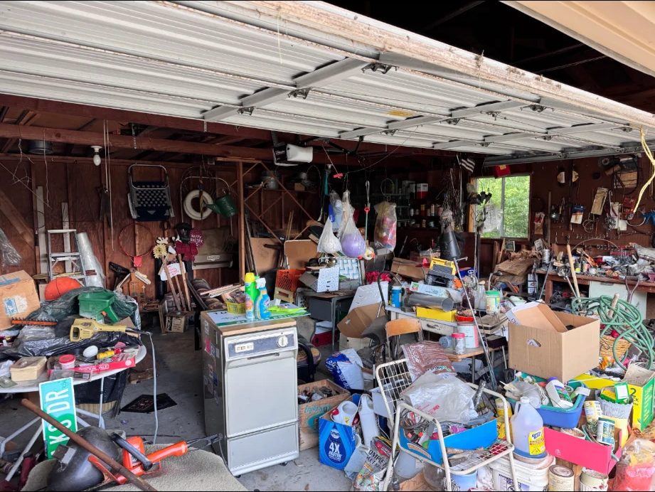 Cluttered two-car garage before a cleanout in Allen Park, MI
