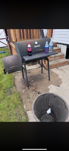Old grill, trash, and clutter by the back steps before a property cleanup in Westland, MI