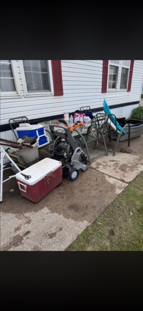 Outdoor clutter by a home before a property cleanup in Westland, MI